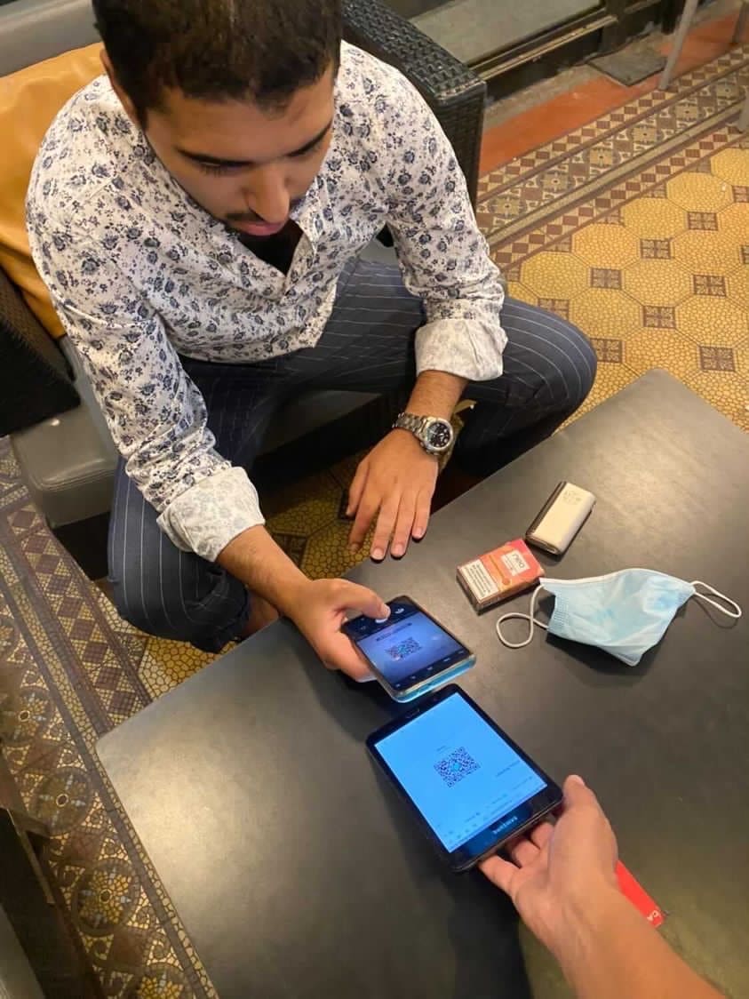 Customer is scanning a QR code to leave a cashless tip to a worker with TackPay